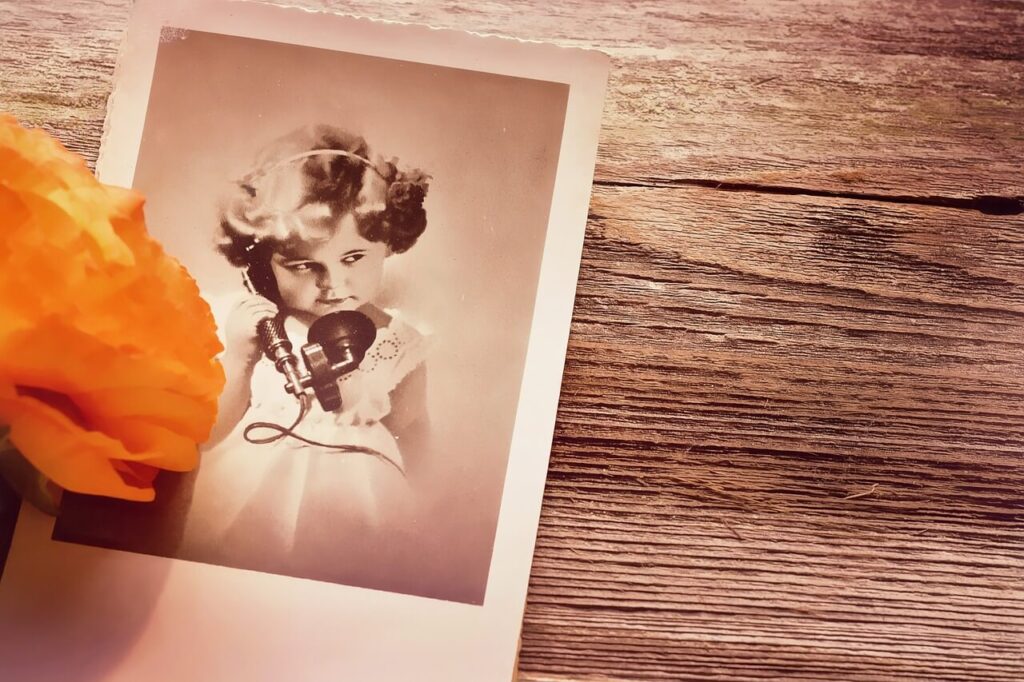 Vintage Postcard with image of child using a telephone.