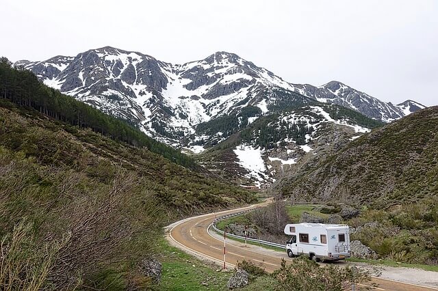Recreational vehicle driving through the mountains.