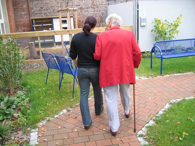 Mother and daughter walking at a senior care living center.