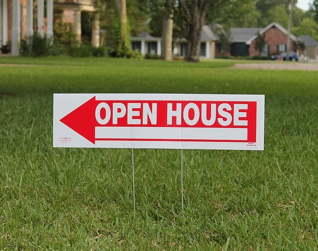 Open house sign in a yard.