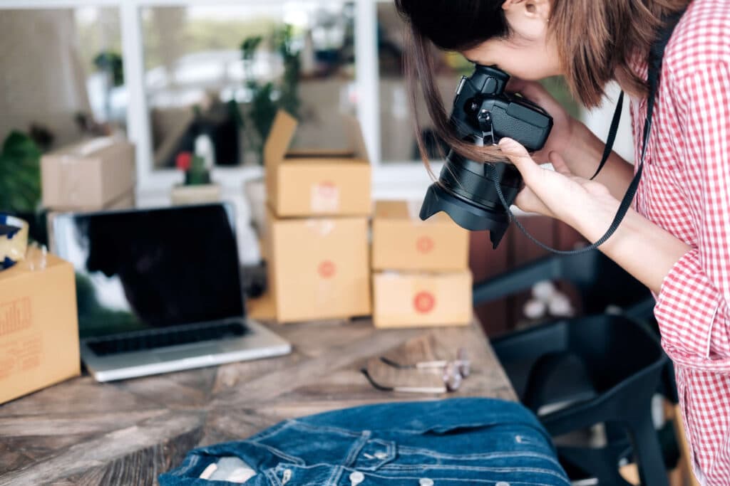 Person taking photo of a denim jacket.