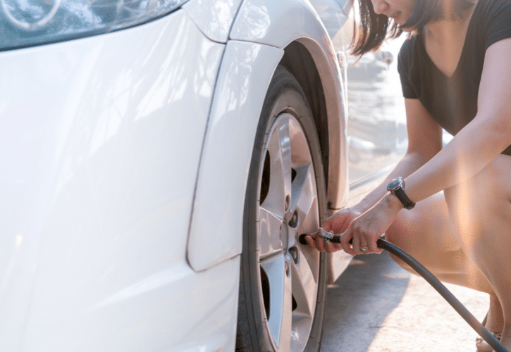 Person filling car tires with air.