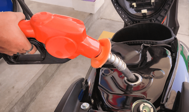 Filling a motorcycle gas tank before storing.