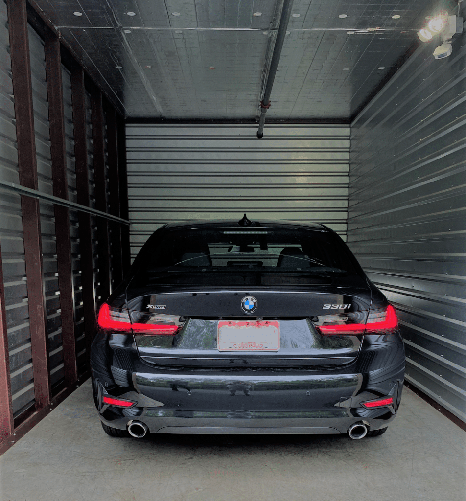 Black BMW sedan parked in a 10x20 foot storage unit.