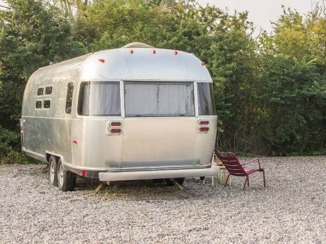 Airstream camper trailer parked at a campsite.
