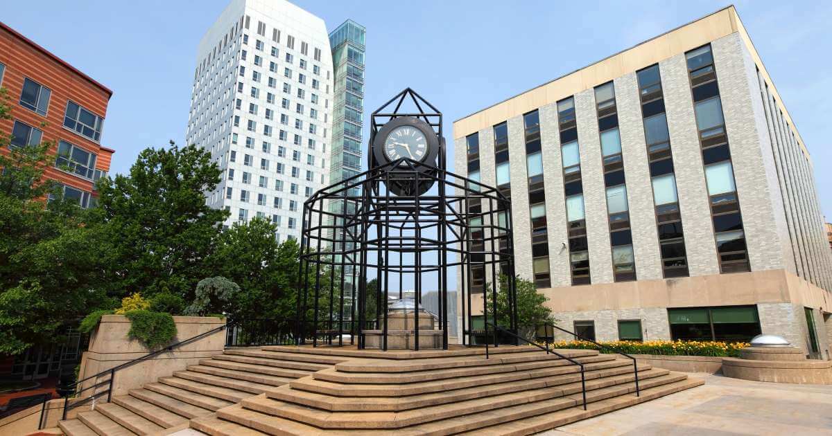 A photo of a large clock on the campus of northeastern university in Boston