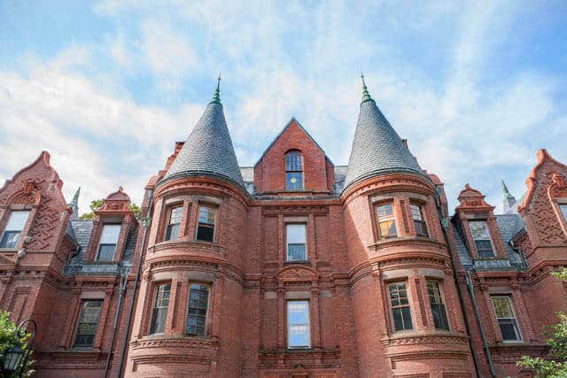 photos of a old brick building with two steeples on wellesley college campus in boston