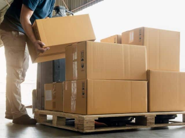 Boxes stacked on a pallet in a storage unit.