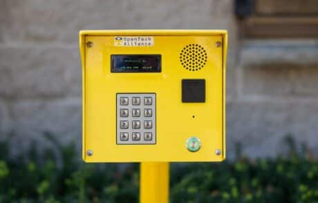 bright yellow entry keypad mounted on a pole