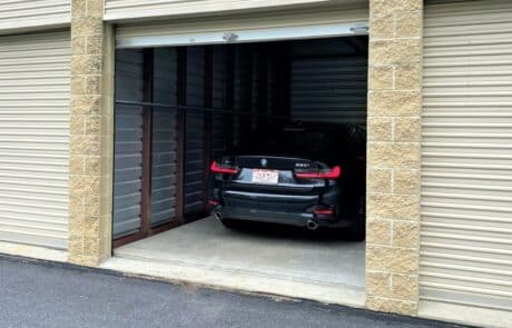 black sedan parked in a storage garage