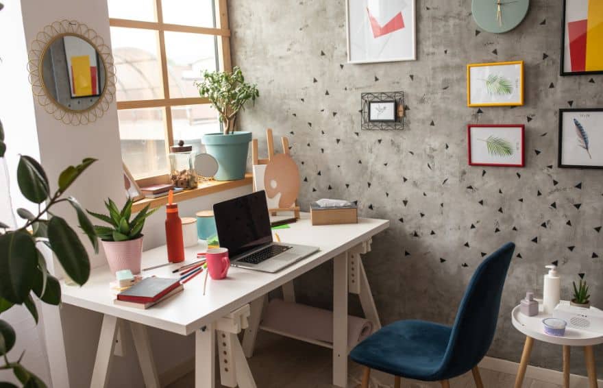 desk and chair in a home office with a computer laptop and other times